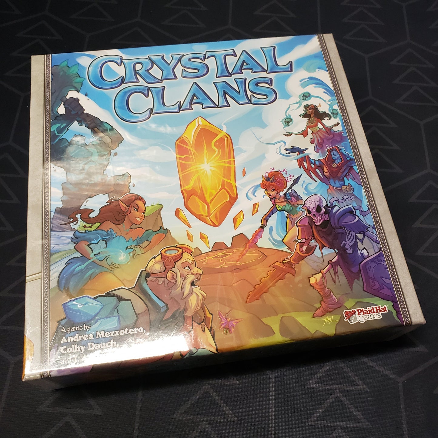 Image shows the front cover of the box of the Crystal Clans card game