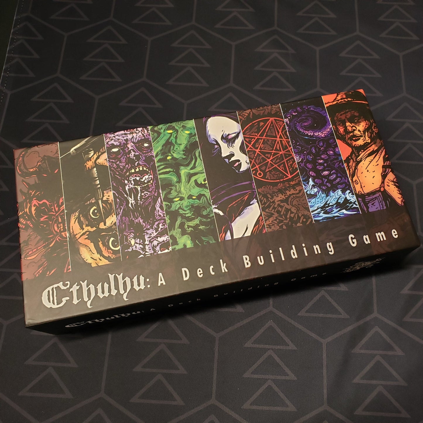 Image shows the front cover of the box for the Cthulhu: A Deck Building Game card game