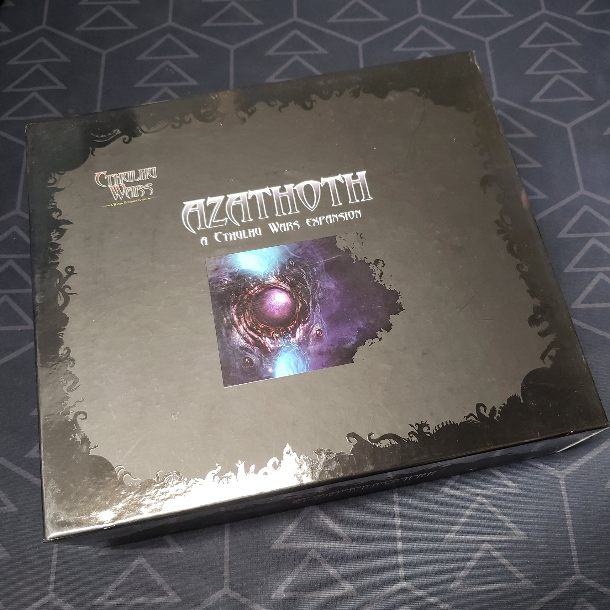 Image shows the front cover of the box of the Azathoth expansion for the board game Cthulhu Wars