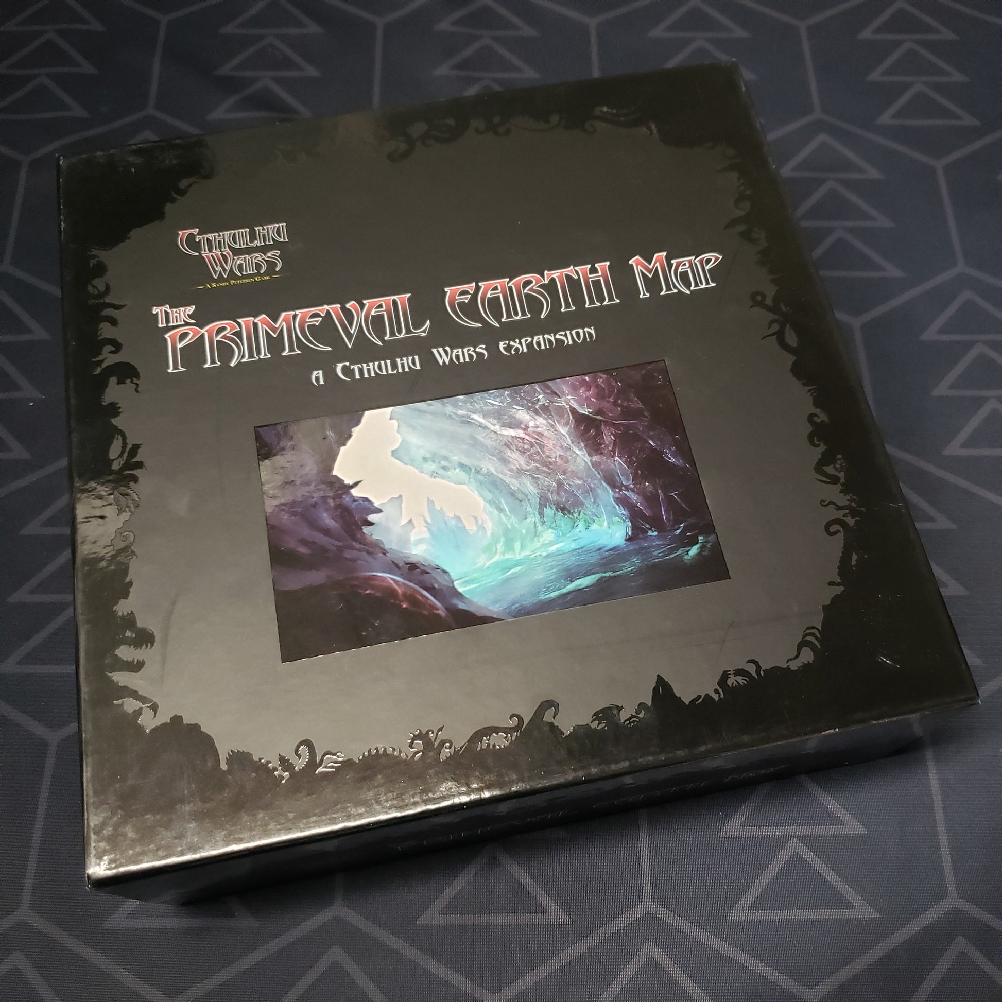 Image shows the front cover of the box of the Primeval Earth Map expansion for the board game Cthulhu Wars