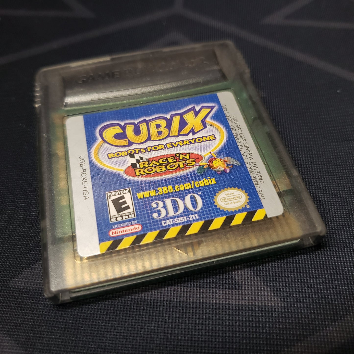 Image shows the front of the cartridge for the video game Cubix: Robots for Everyone - Race 'N Robots for Nintendo Game Boy Color