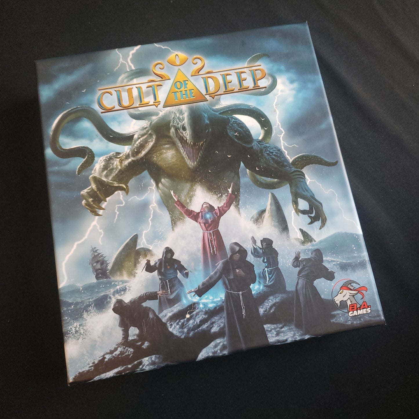 Image shows the front cover of the box of the Cult of the Deep board game