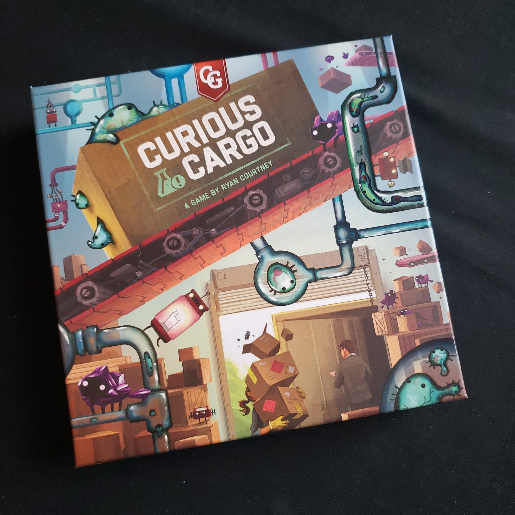 Image shows the front cover of the box of the Curious Cargo board game