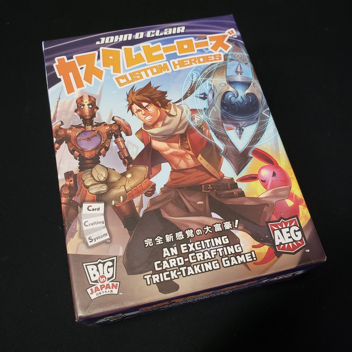 Image shows the front cover of the box of the Custom Heroes card game