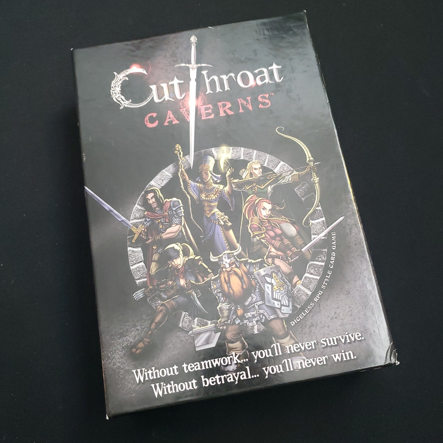 Image shows the front cover of the box of the Cutthroat Caverns board game