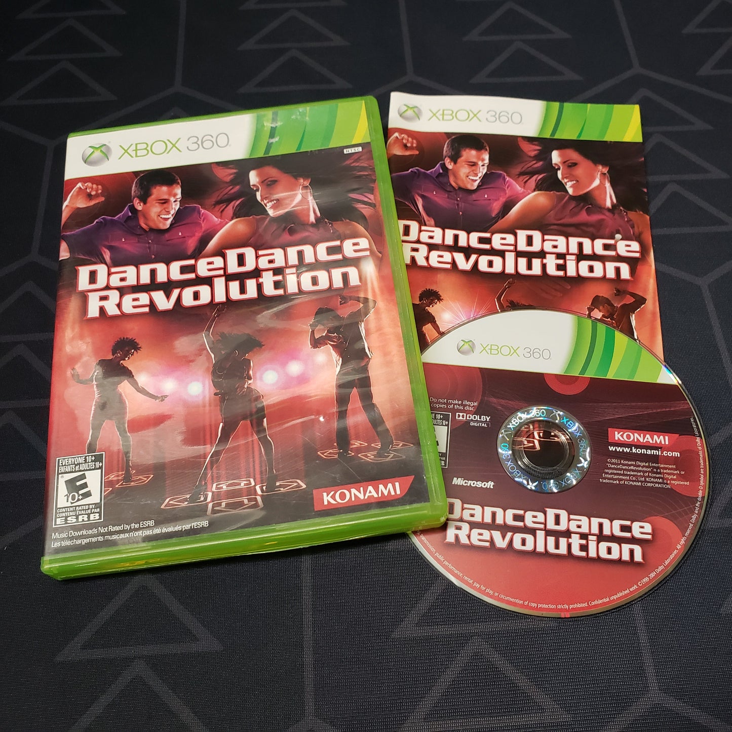 Image shows the case, manual & disc for the video game Dance Dance Revolution for Xbox 360