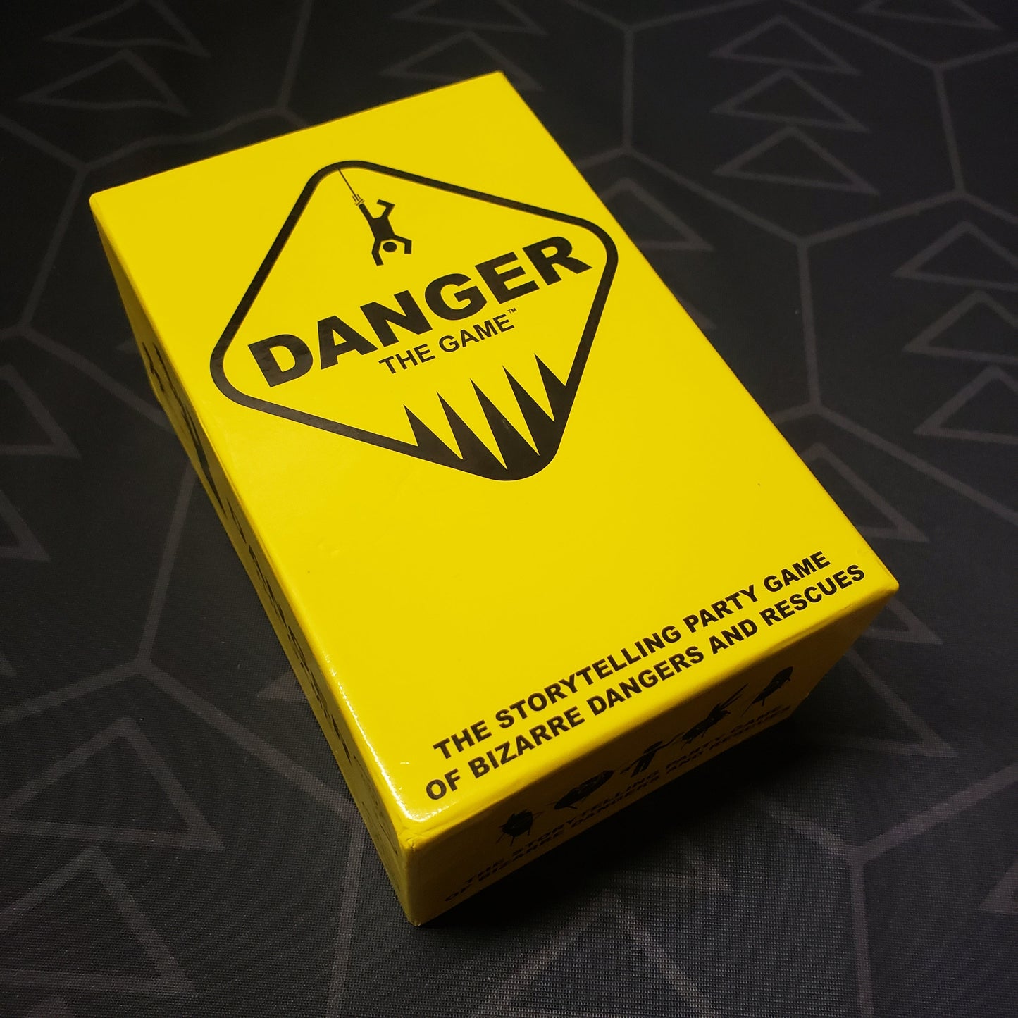 Image shows the front cover of the box for the card game Danger: The Game