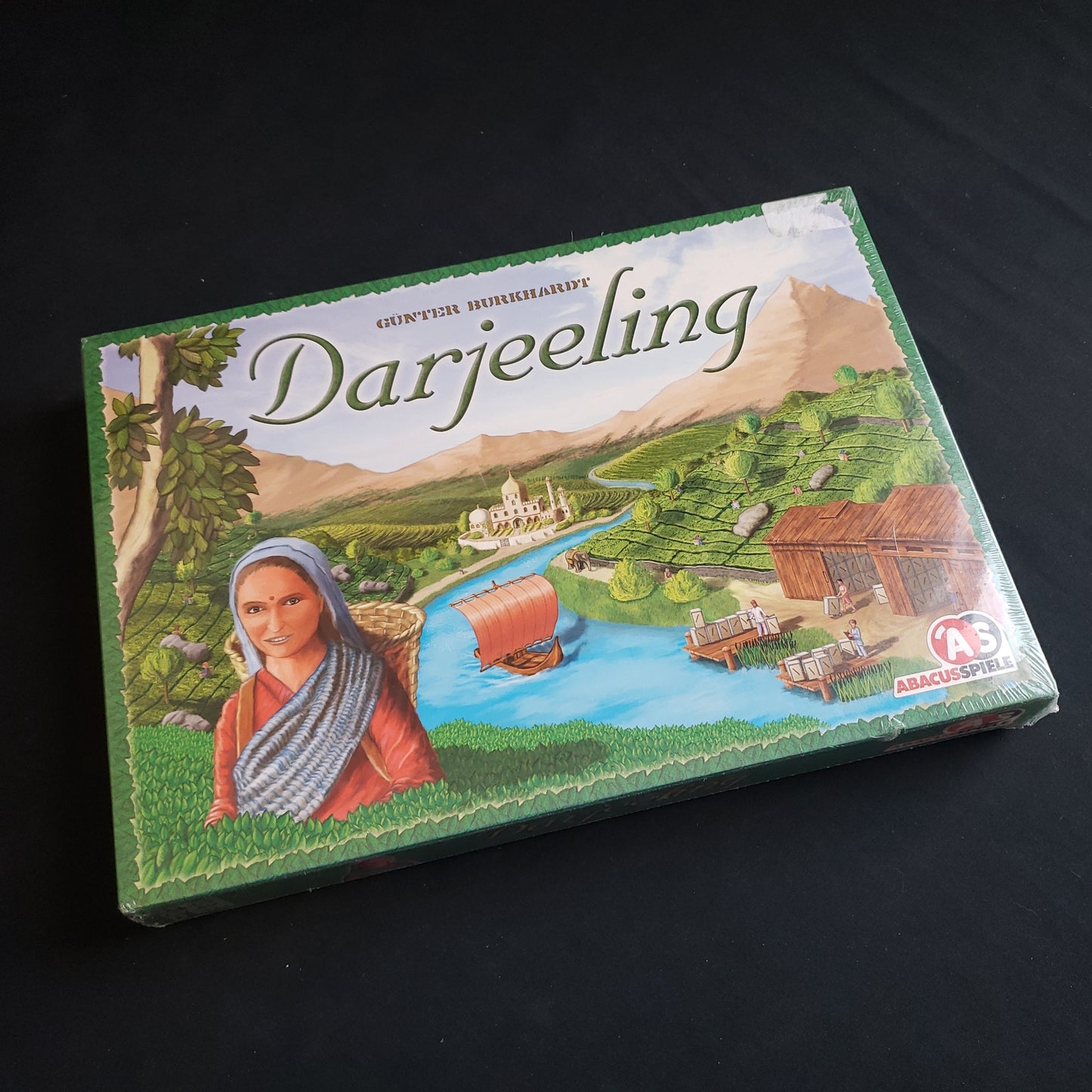 Image shows the front cover of the box of the Darjeeling board game