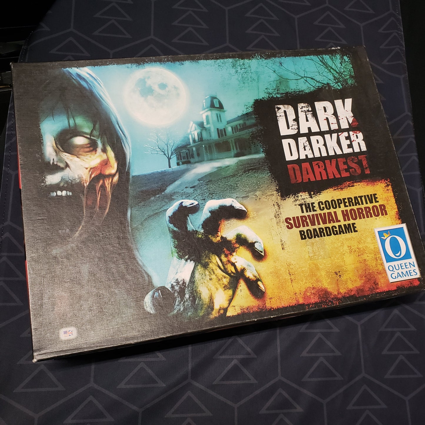 Image shows the front cover of the box of the Dark Darker Darkest board game