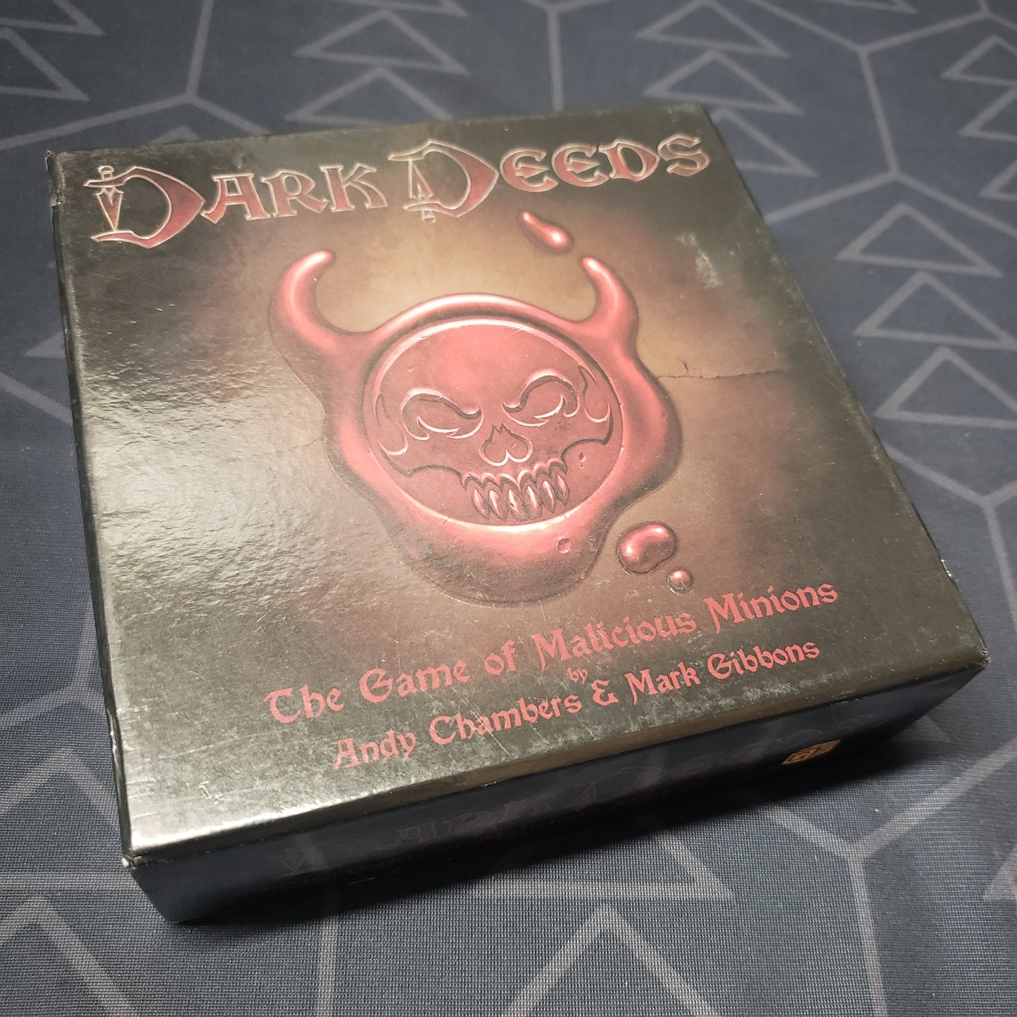Image shows the front cover of the box for the Dark Deeds card game