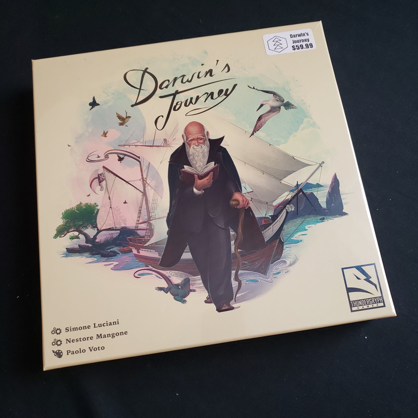 Image shows the front cover of the box of the Darwin's Journey board game