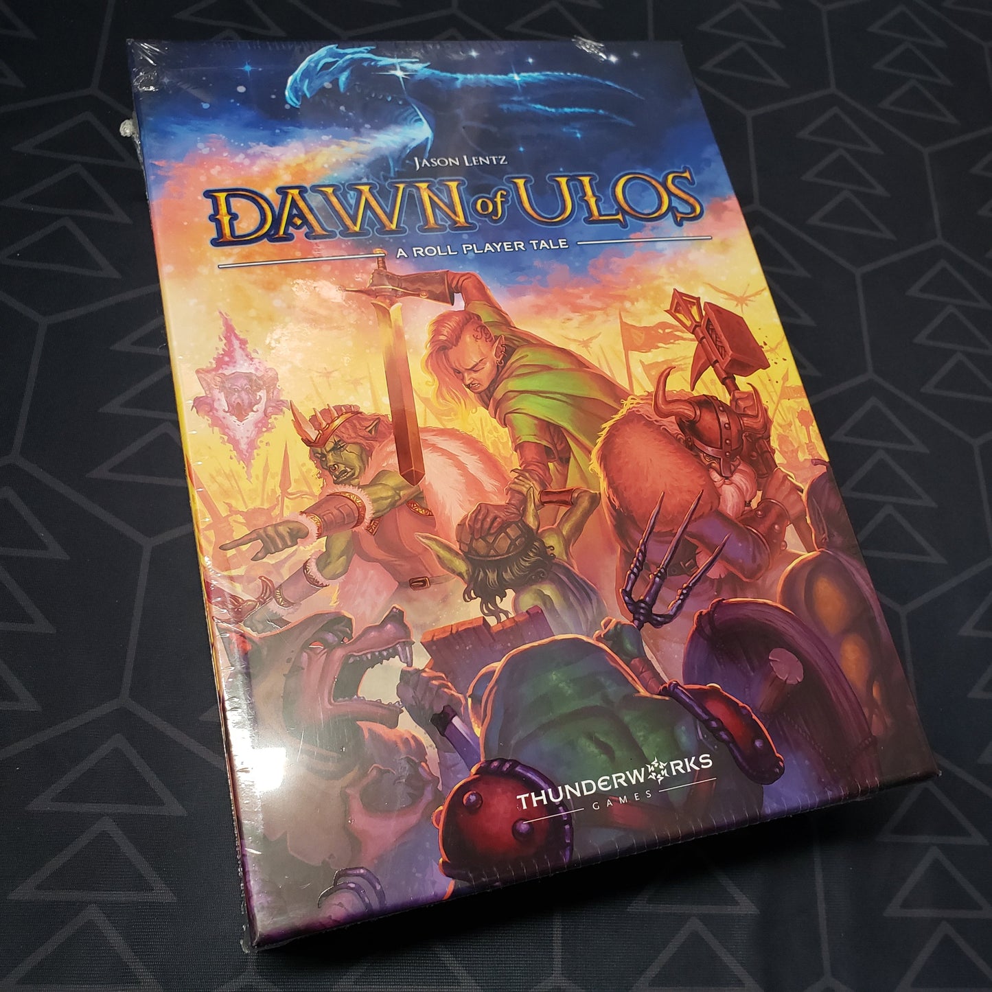 Image shows the front cover of the box of the Dawn of Ulos board game