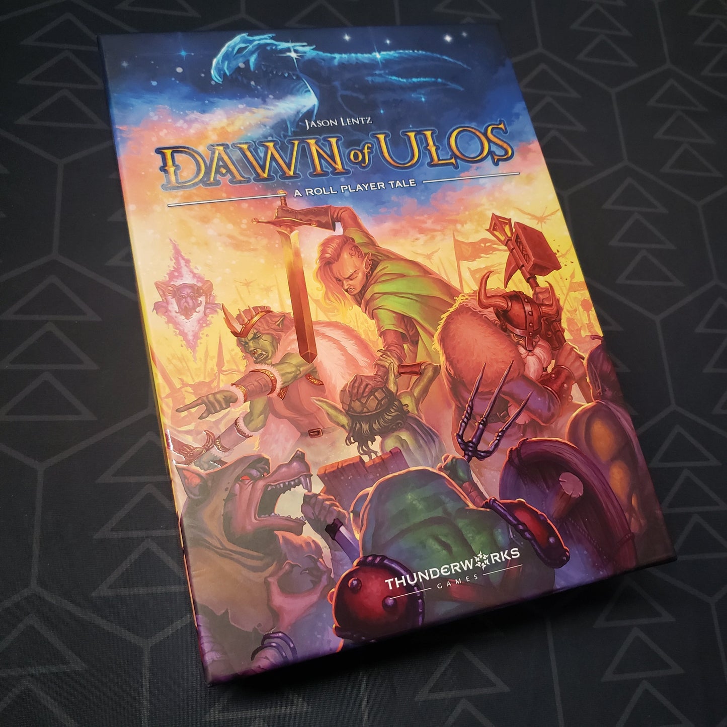 Image shows the front cover of the box of the Dawn of Ulos board game