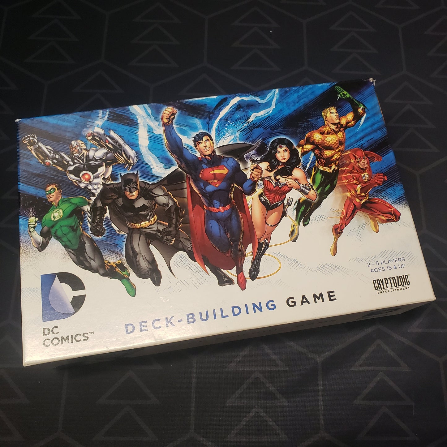 Image shows the front cover of the box of the DC Comics Deckbuilding card game
