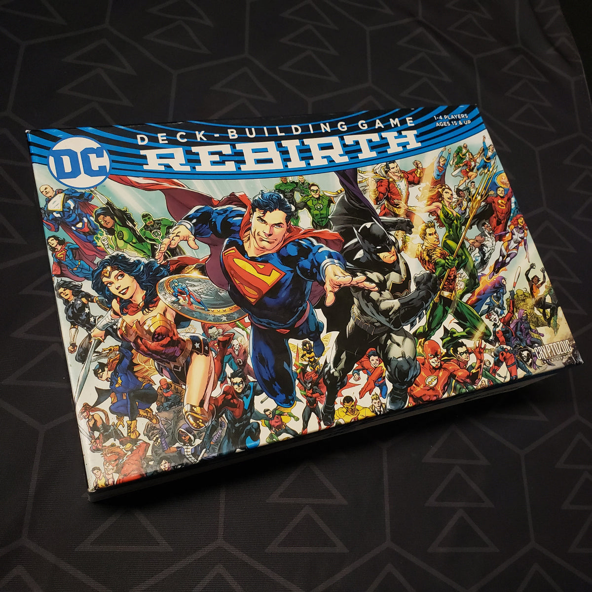 Image shows the front of the box for the Rebirth base game for the DC Comics Deckbuilding card game