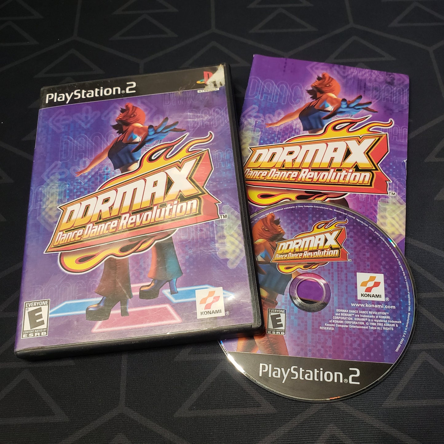 Image shows the case, manual & disc for the video game DDRMAX: Dance Dance Revolution for Playstation 2