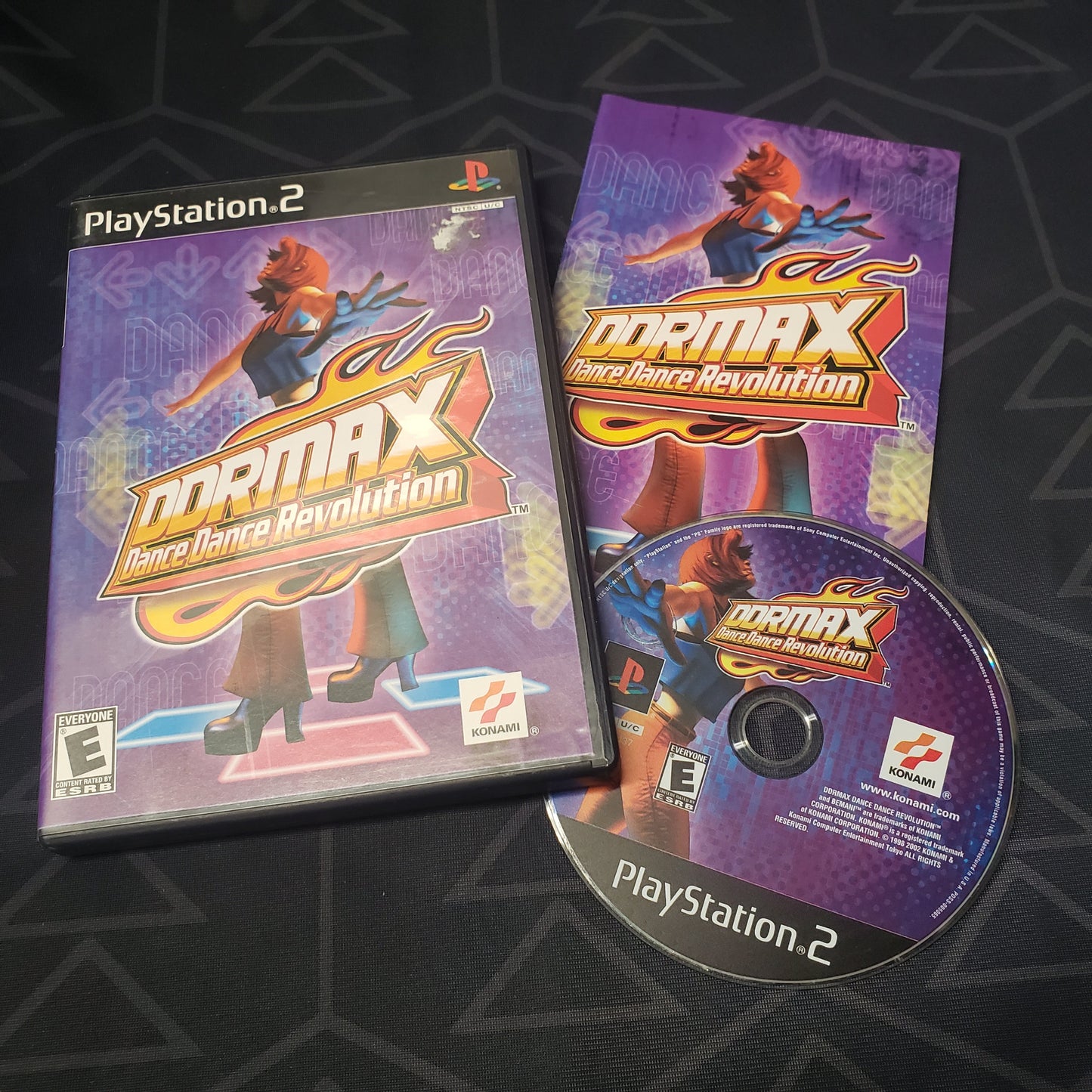 Image shows the case, manual & disc for the video game DDRMAX: Dance Dance Revolution for Playstation 2