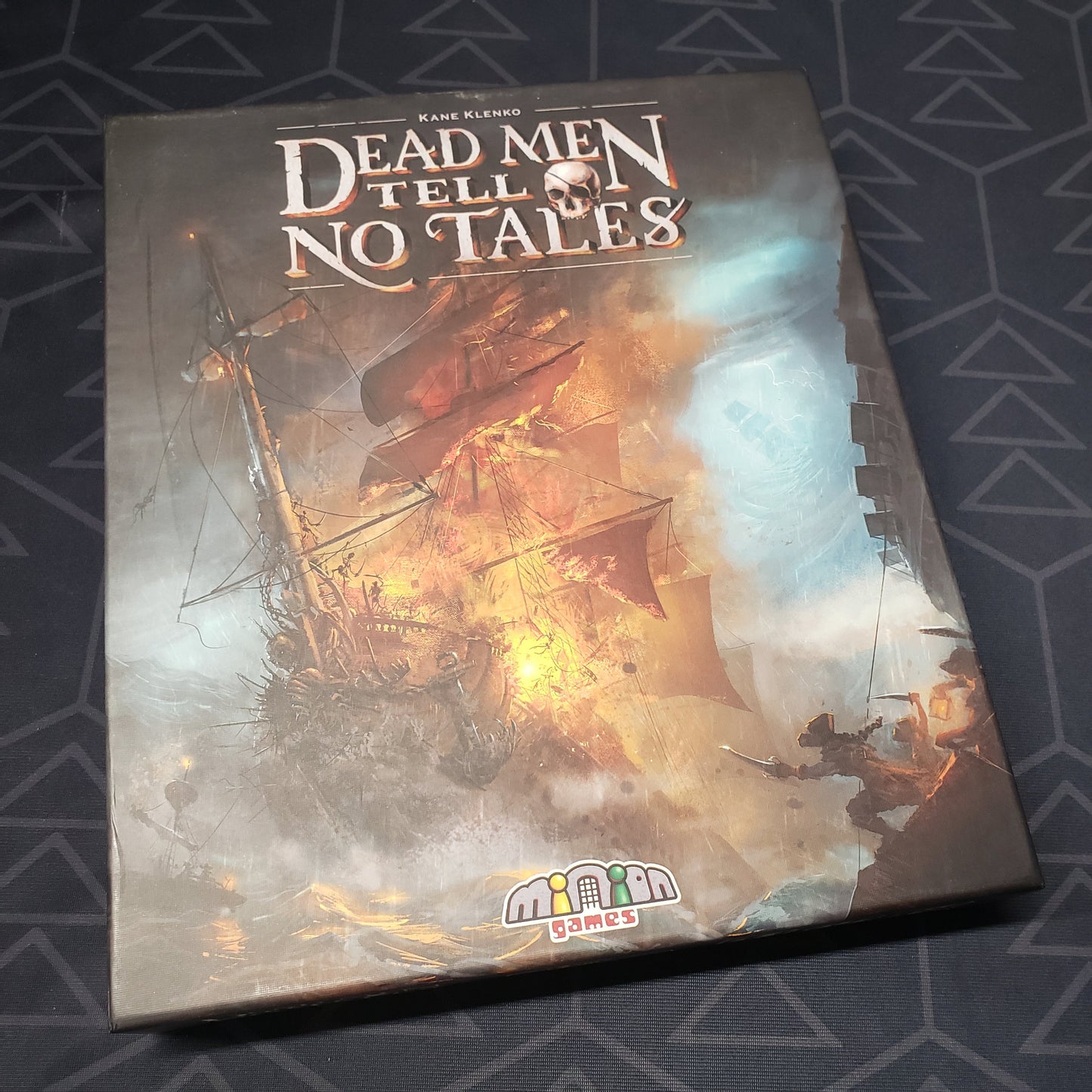 Image shows the front cover of the box of the Dead Men Tell No Tales board game
