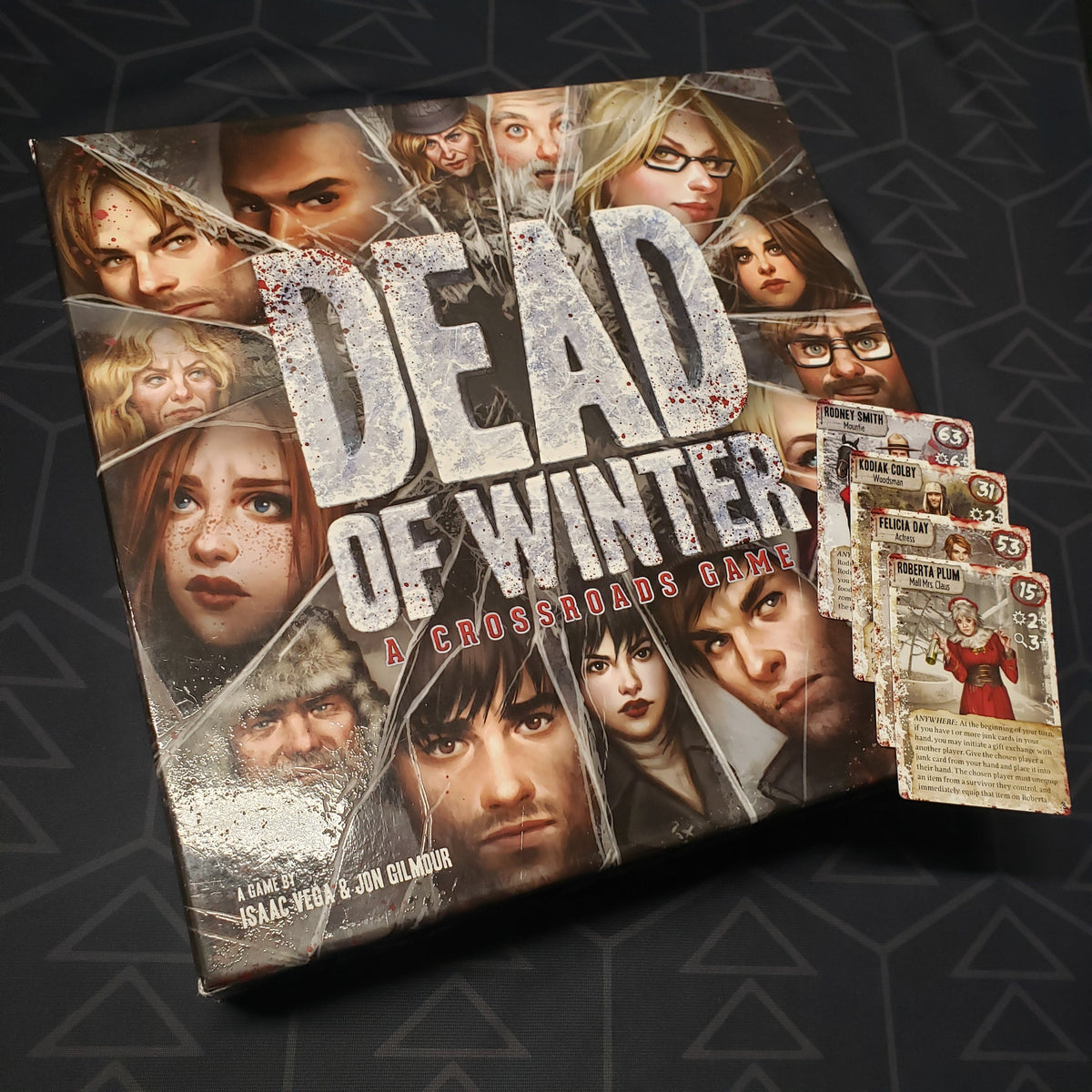 Image shows the front cover of the box of the Dead of Winter board game