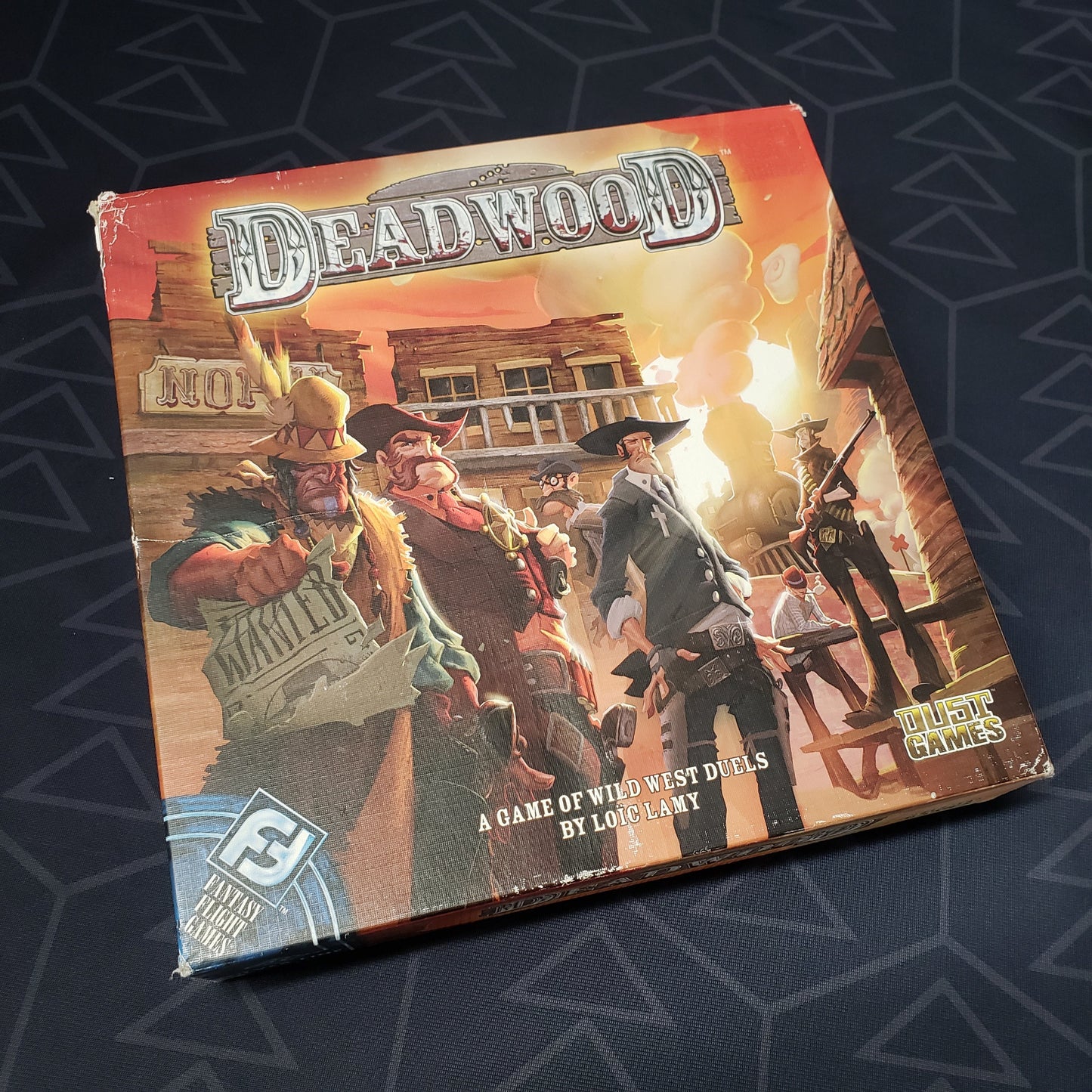Image shows the front cover of the box of the Deadwood board game