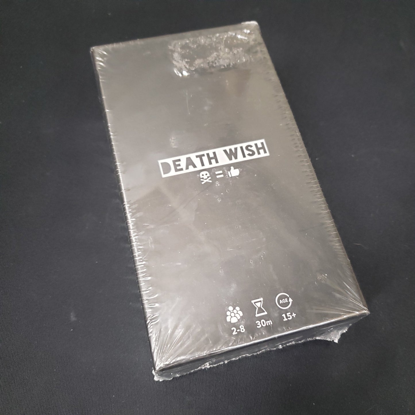Image shows the front cover of the box of the Death Wish card game