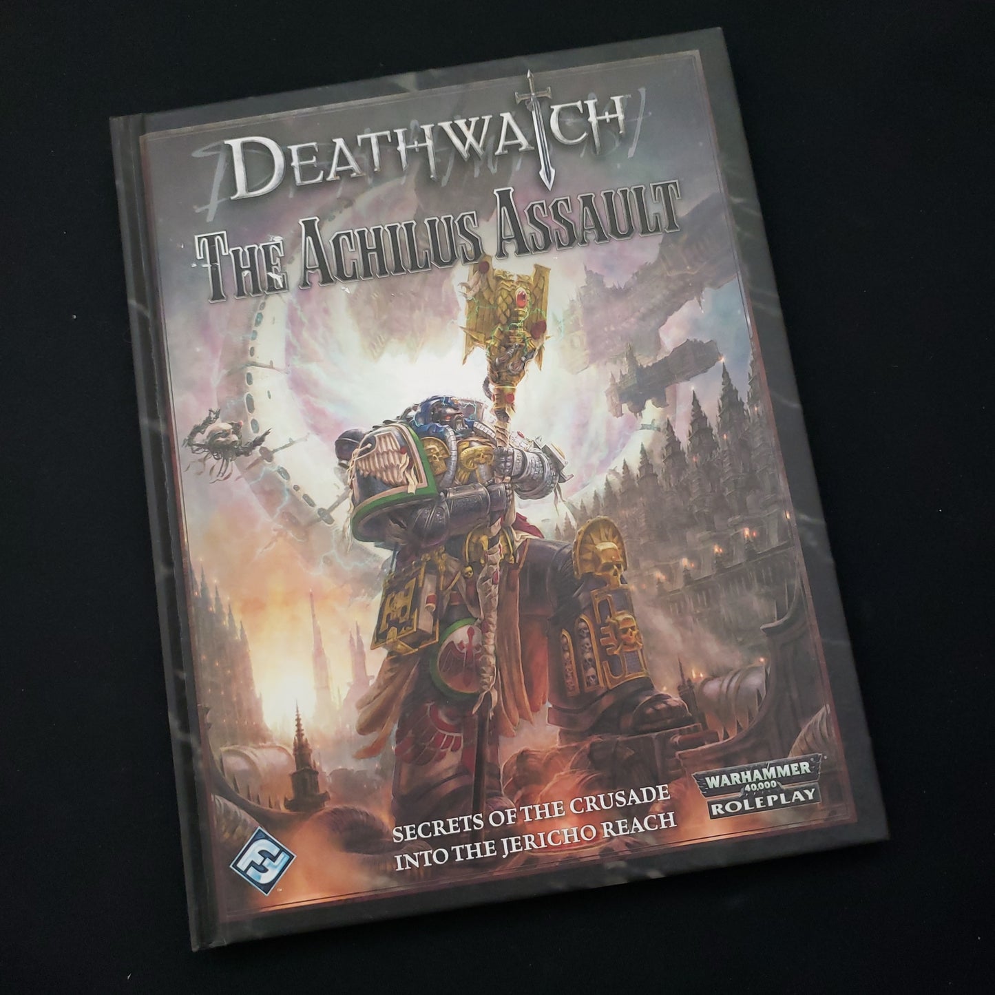 Image shows the front cover of the Achilus Assault book for the Deathwatch roleplaying game