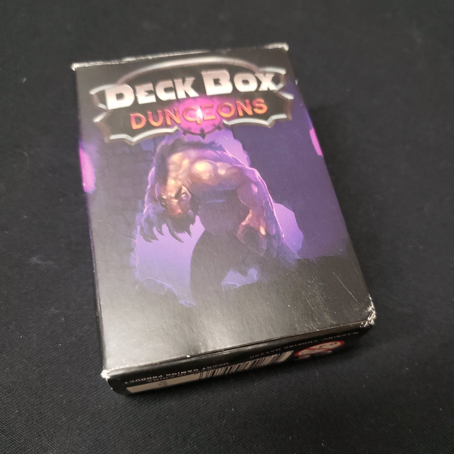 Image shows the front cover of the box of the Deck Box Dungeons card game