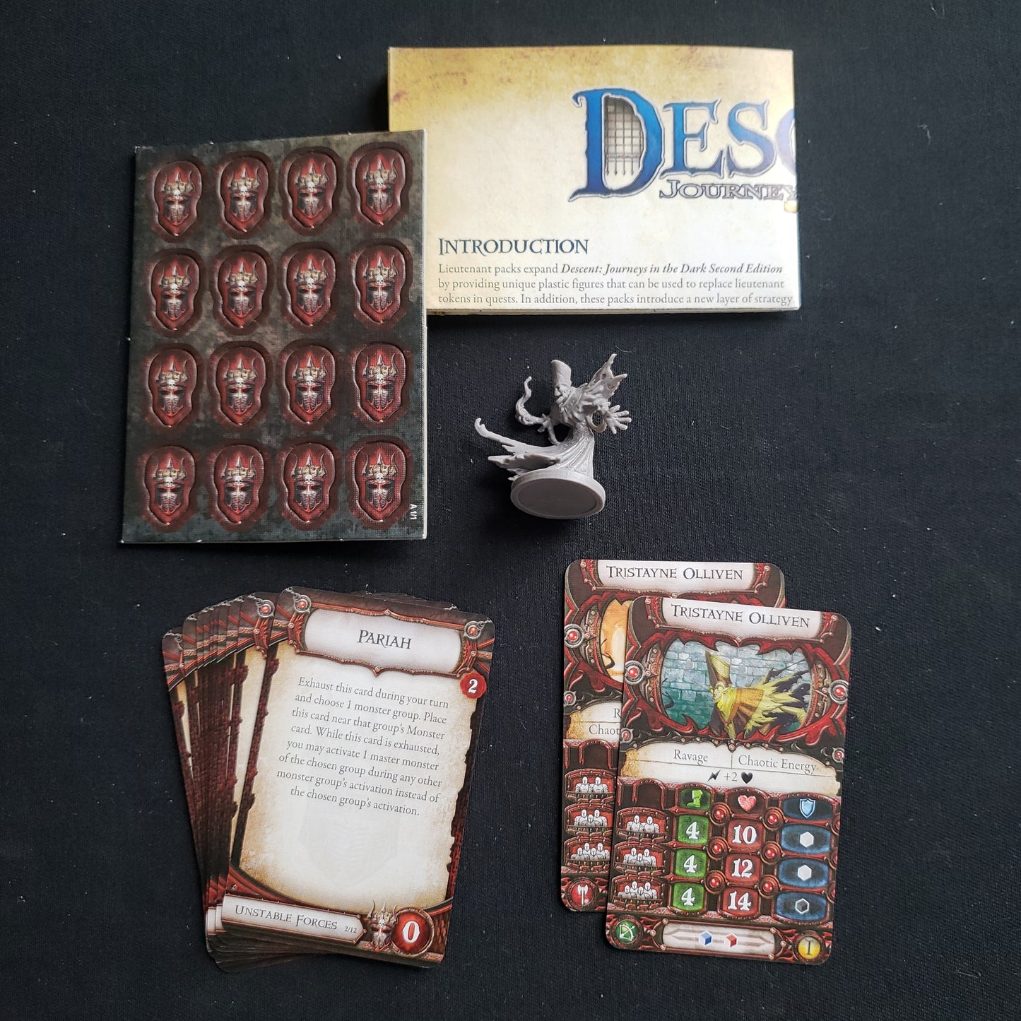Image shows the components and instructions for the Tristayne Olliven Lieutenant Pack expansion for the board game Descent: Journeys in the Dark Second Edition