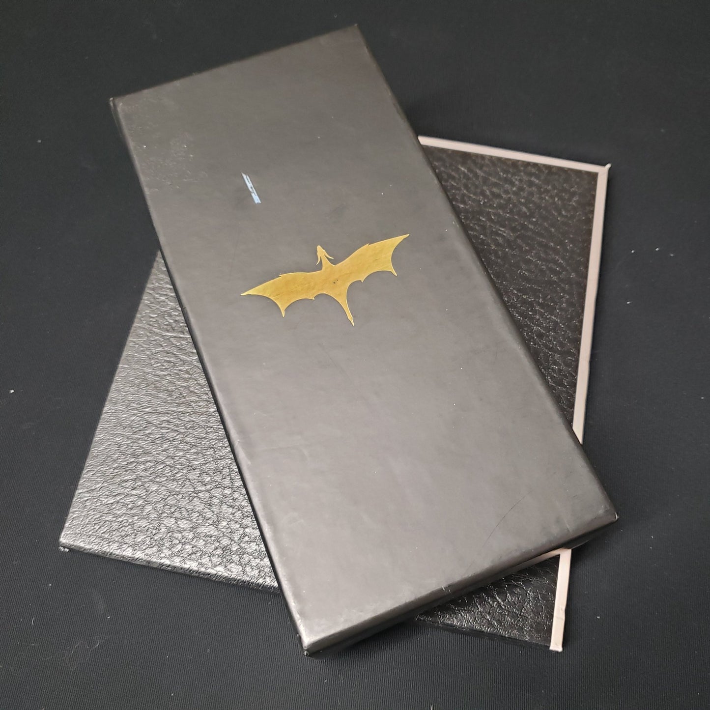 Image shows the front cover of the box of the Destined Legends card game, sitting on top of the board for the game