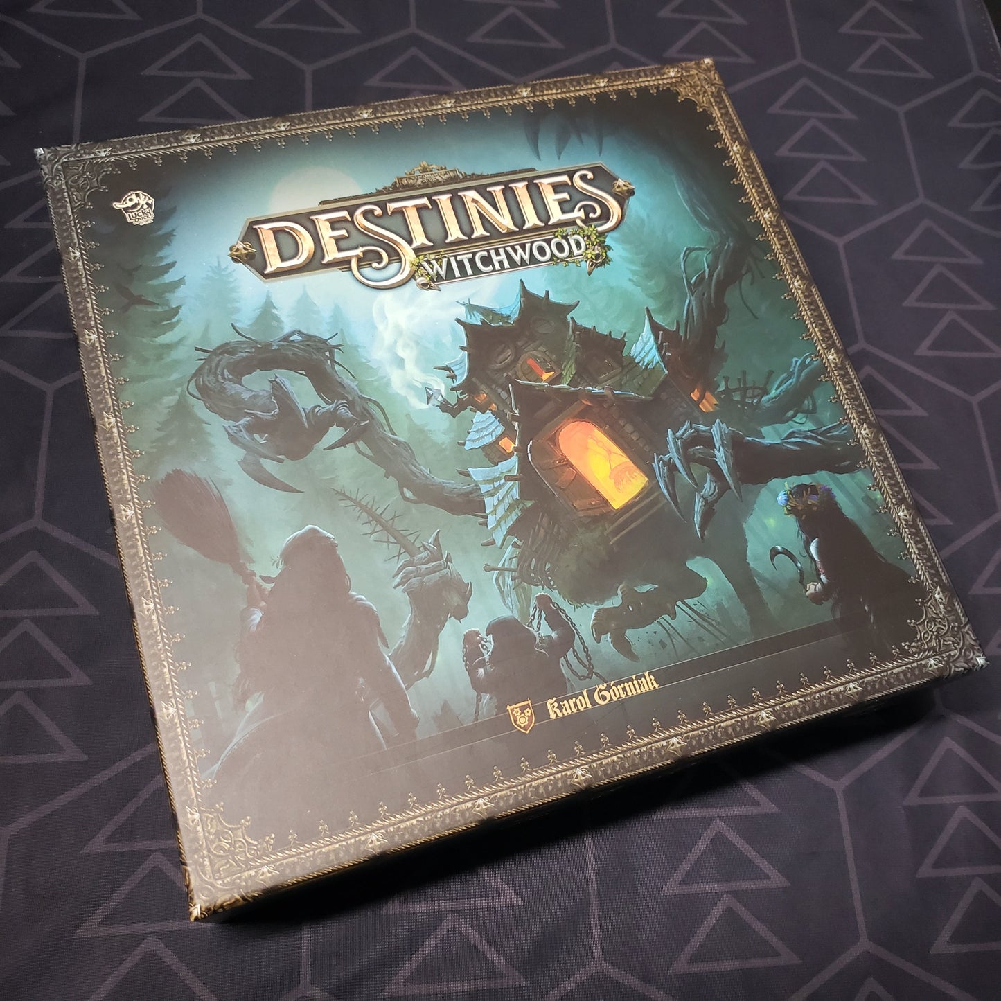 Image shows the front cover of the box of the Witchwood expansion for the board game Destinies