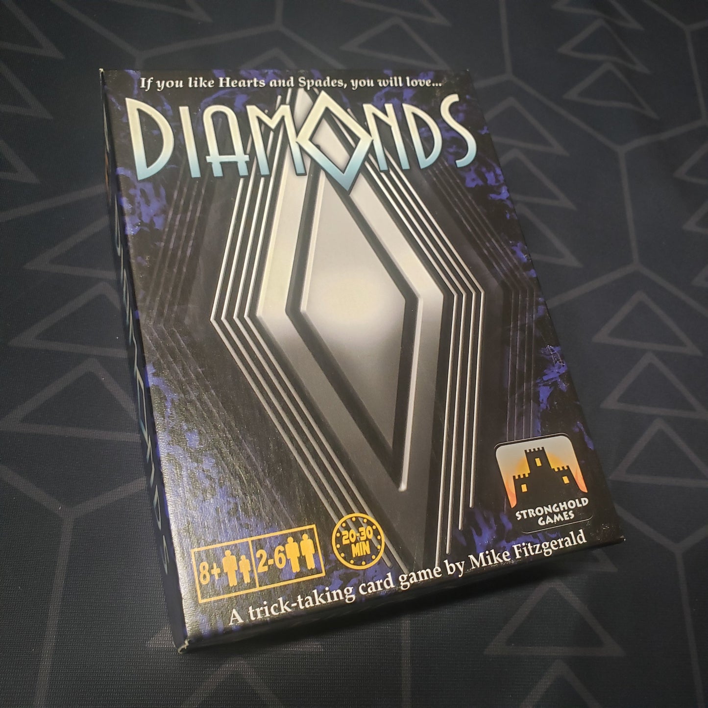 Image shows the front cover of the box of the Diamonds card game