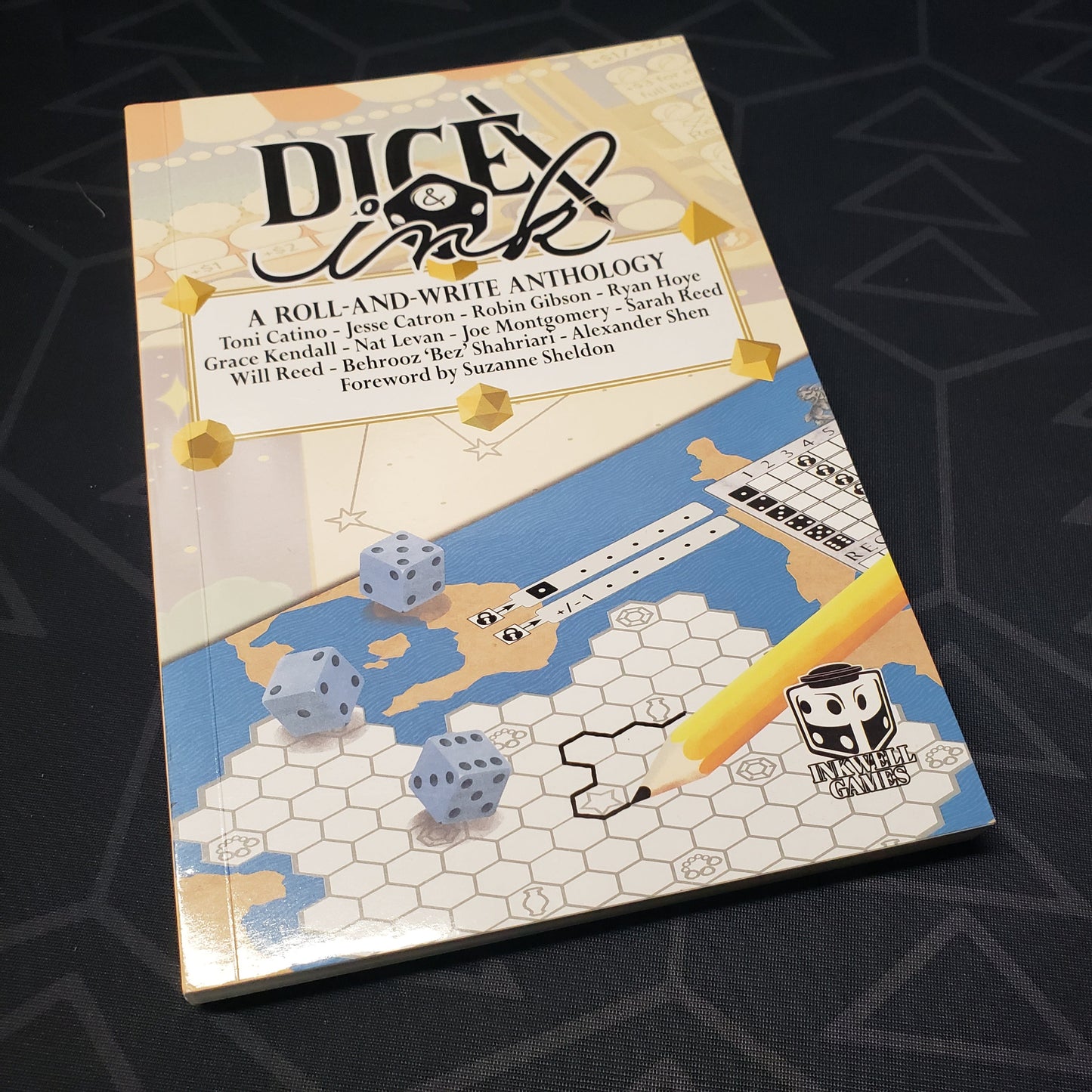 Image shows the front cover of the Dice & Ink: A Roll & Write Anthology gaming book