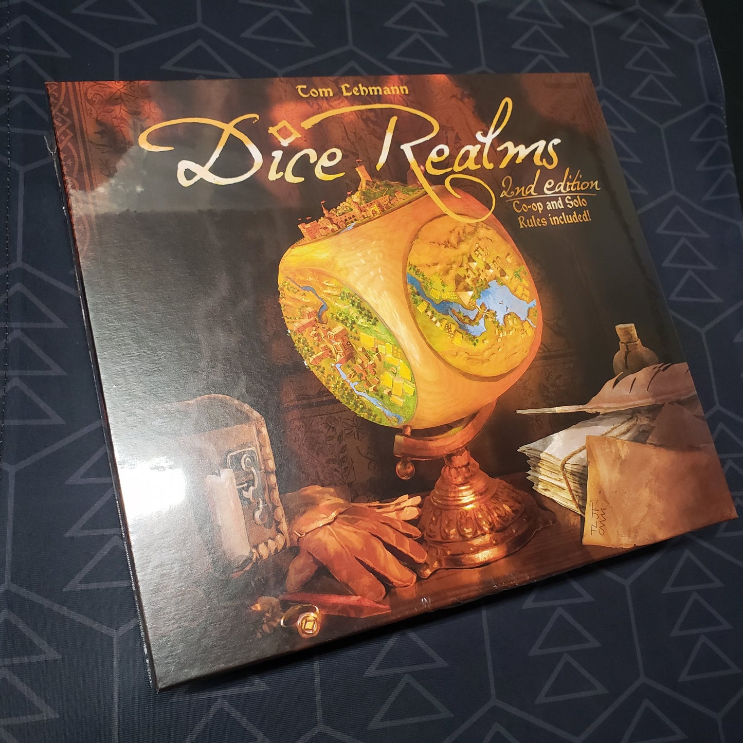 Image shows the front cover of the box for the Dice Realms board game
