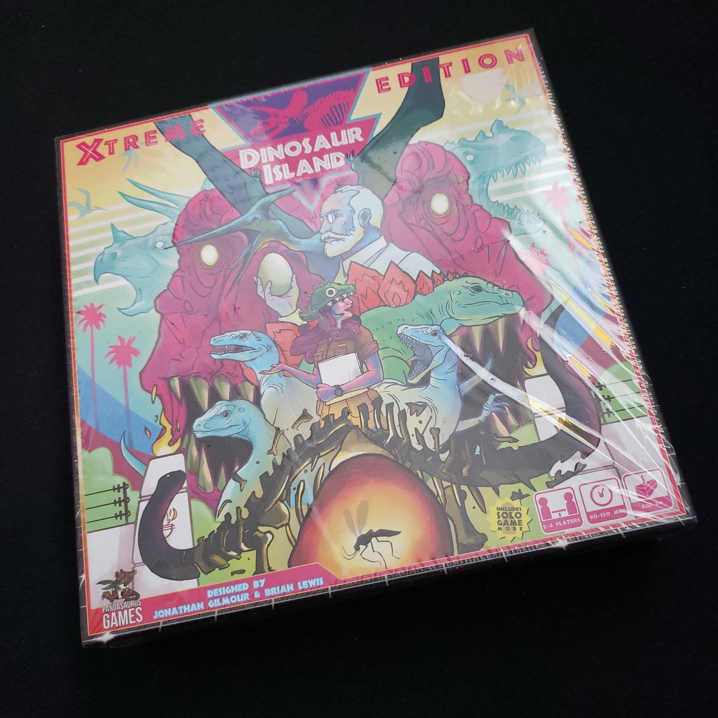 Image shows the front cover of the box of the Dinosaur Island: Xtreme Edition board game