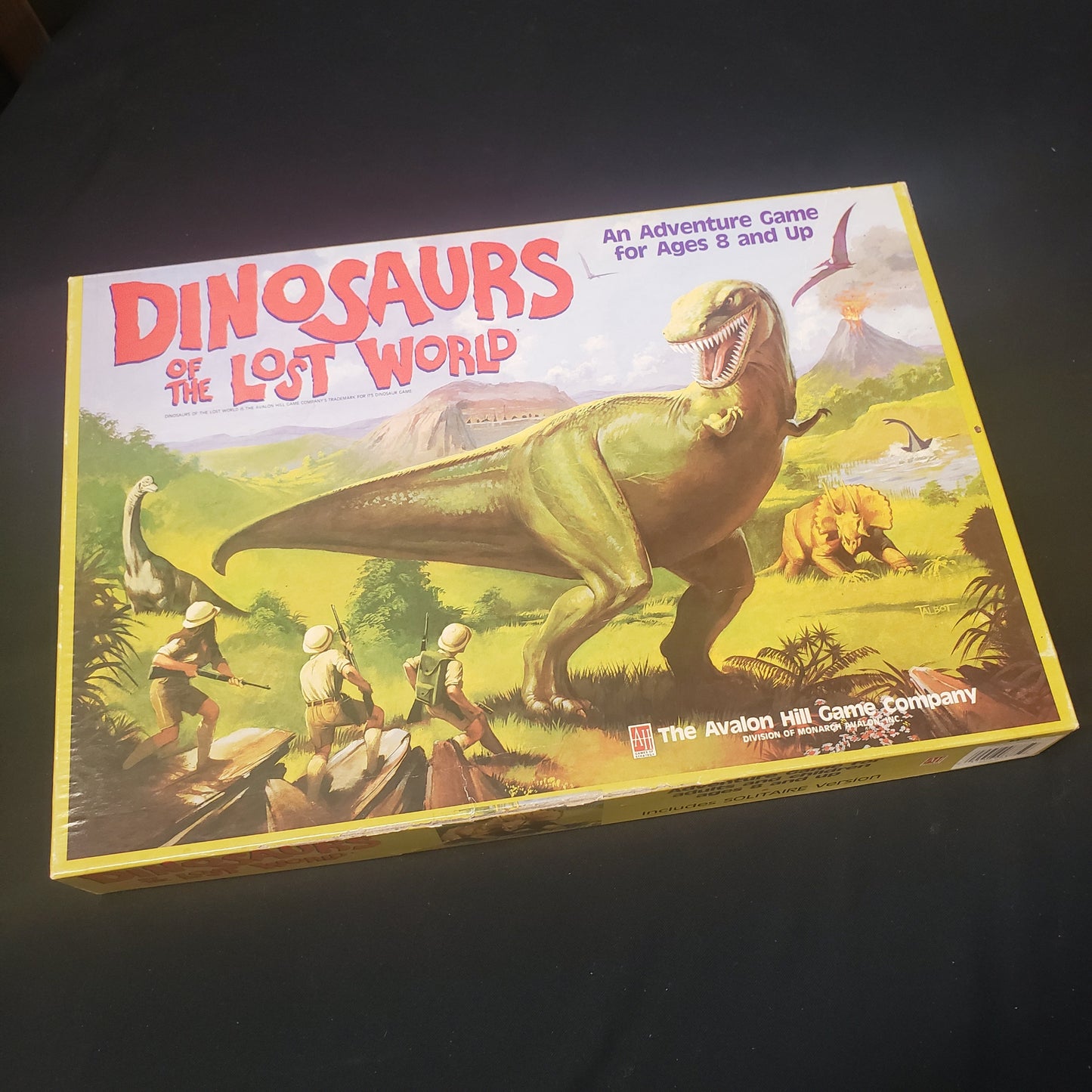 Image shows the front cover of the box of the Dinosaurs of the Lost World board game