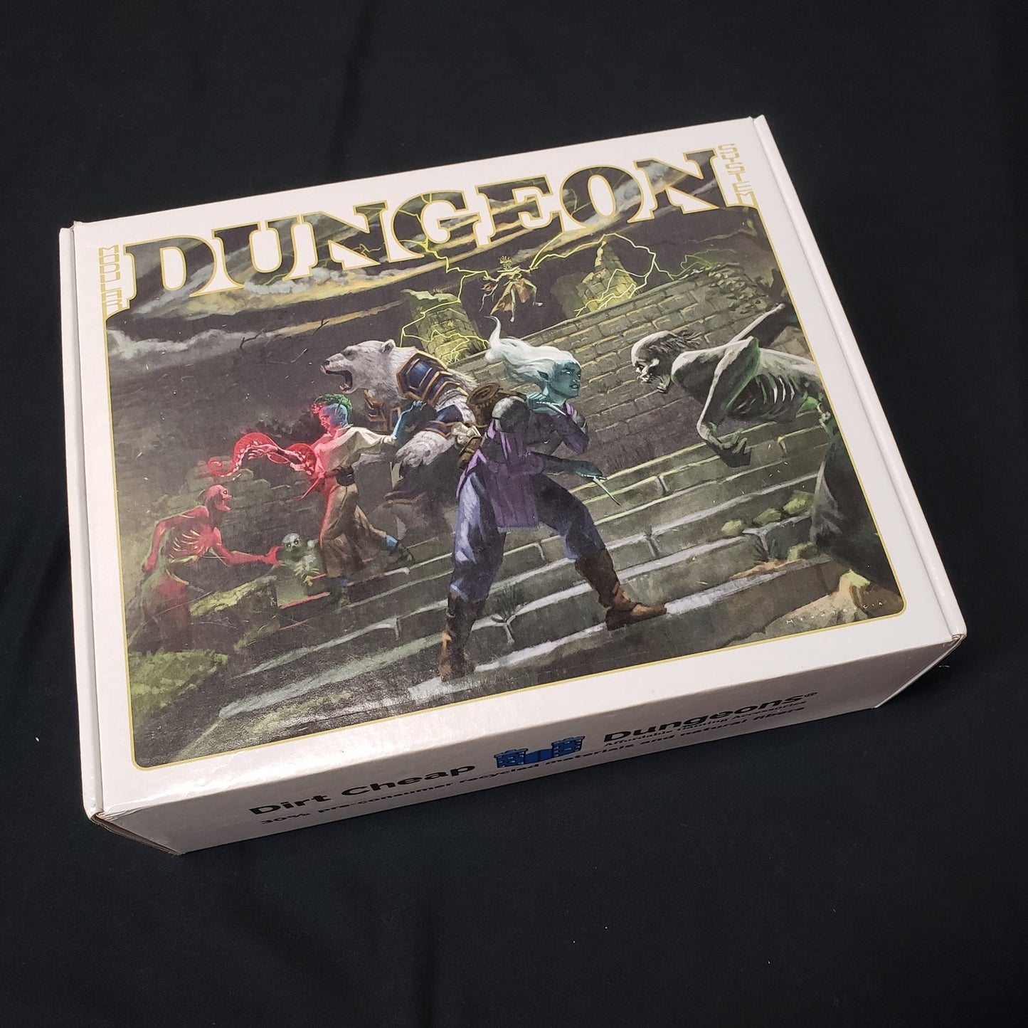 Image shows the front cover of the box of the Legends set for the Dirt Cheap Dungeons modular terrain system