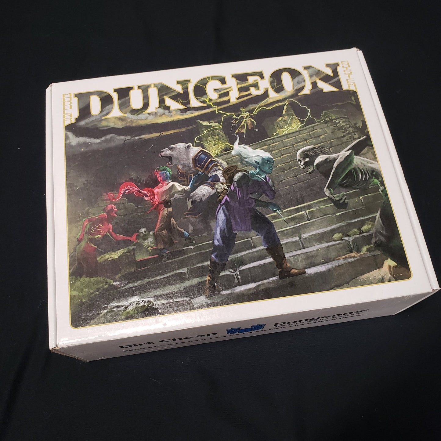 Image shows the front cover of the box of the Legends set for the Dirt Cheap Dungeons modular terrain system