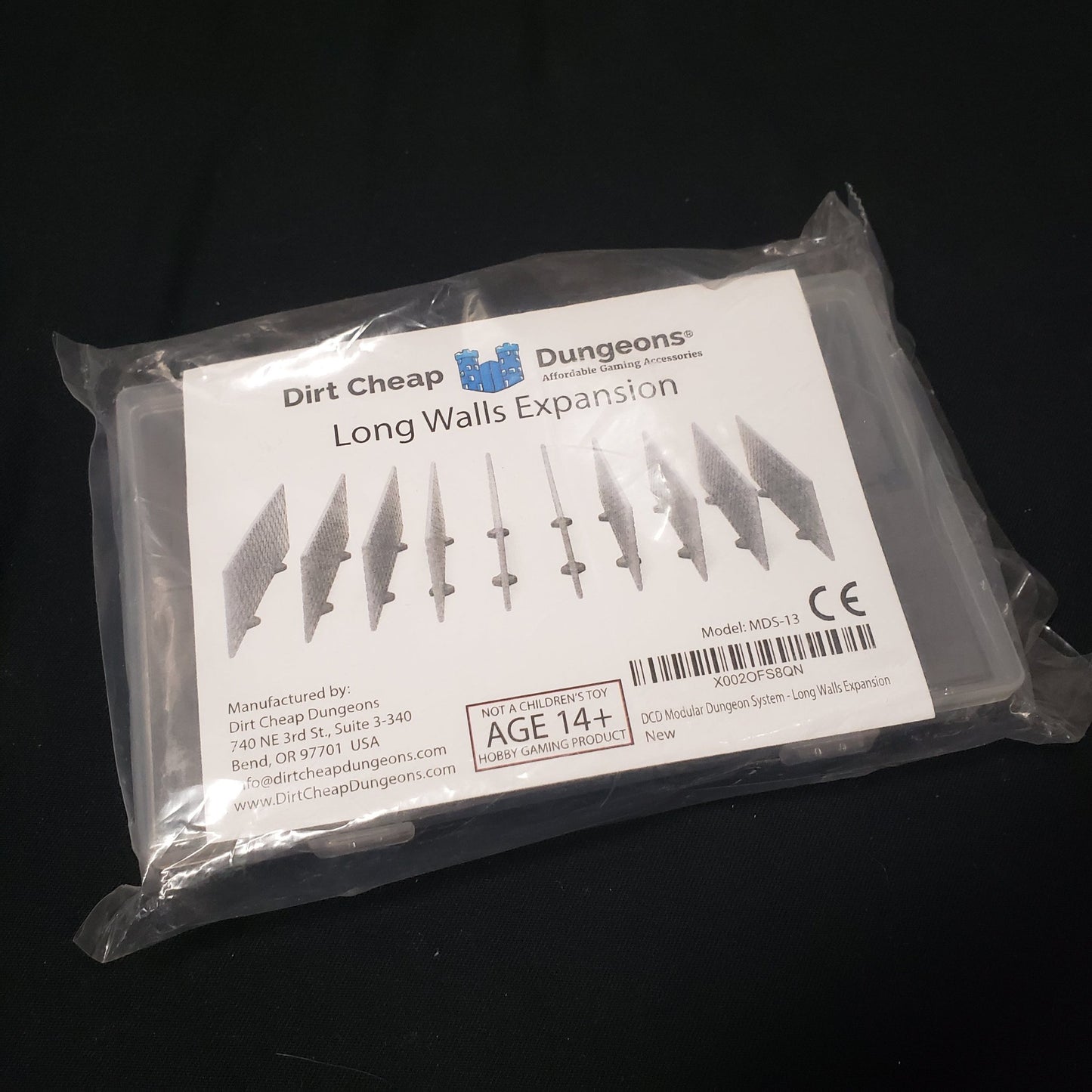 Image shows the front of the packaging of the Long Walls Expansion set for the Dirt Cheap Dungeons modular terrain system