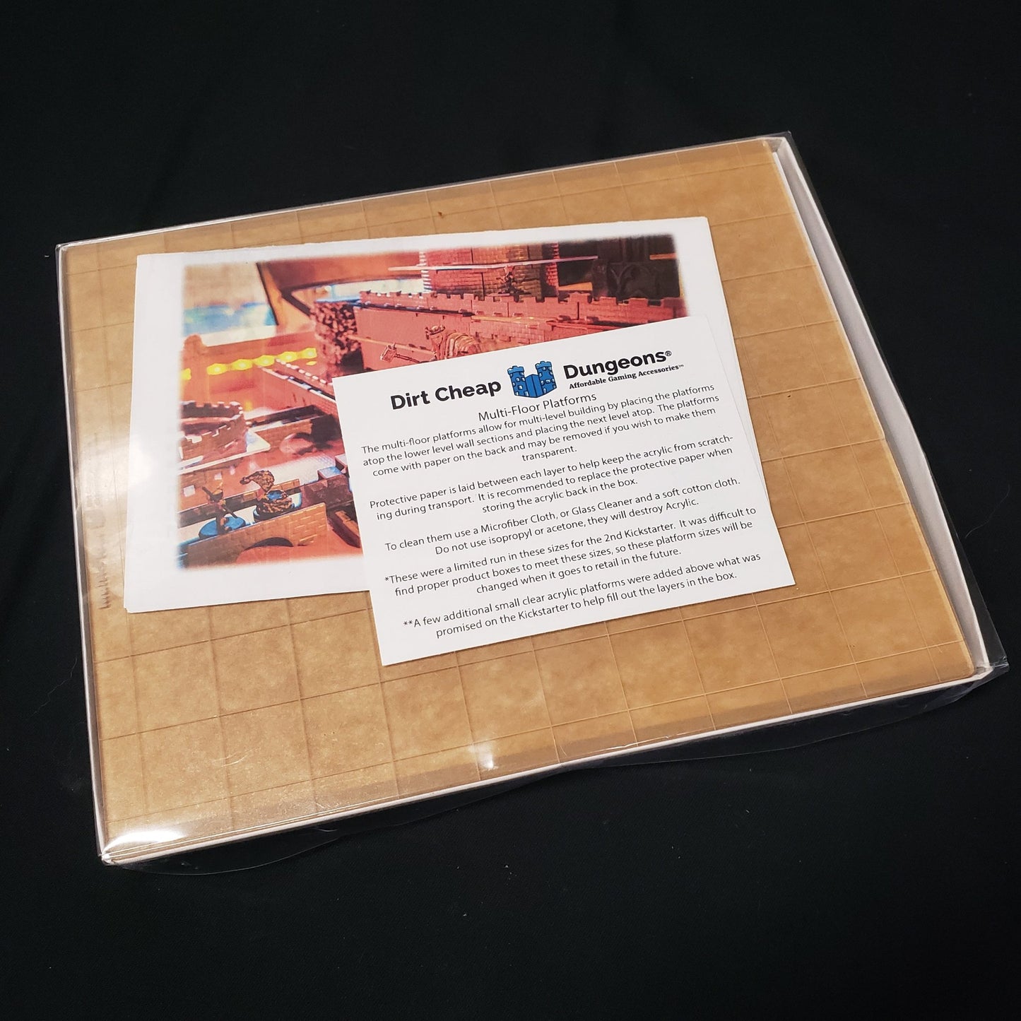 Image shows the front of the packaging of the Multi-Floor Platforms set for the Dirt Cheap Dungeons modular terrain system