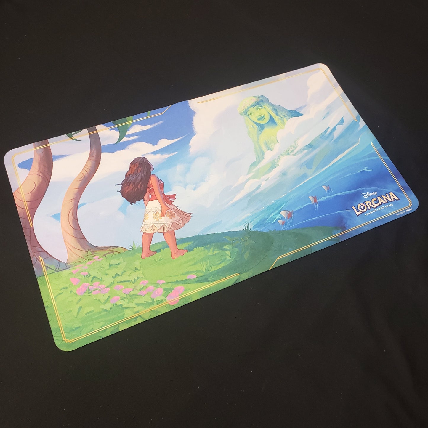 Image shows a playmat featuring Into the Inklands: Moana & Te Fiti art for the Disney Lorcana card game