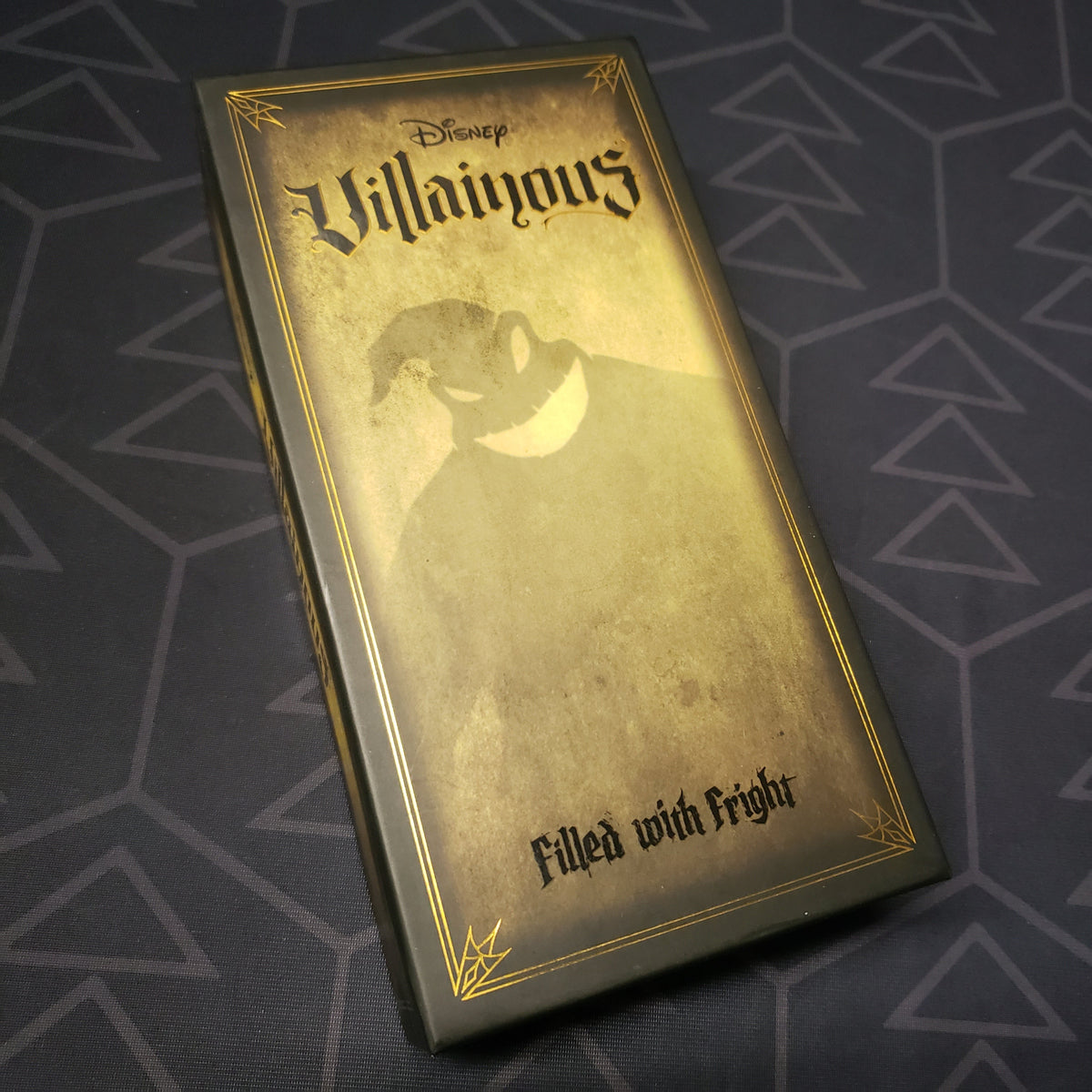 Image shows the front cover of the box of the Filled With Fright expansion for the card game Disney Villainous