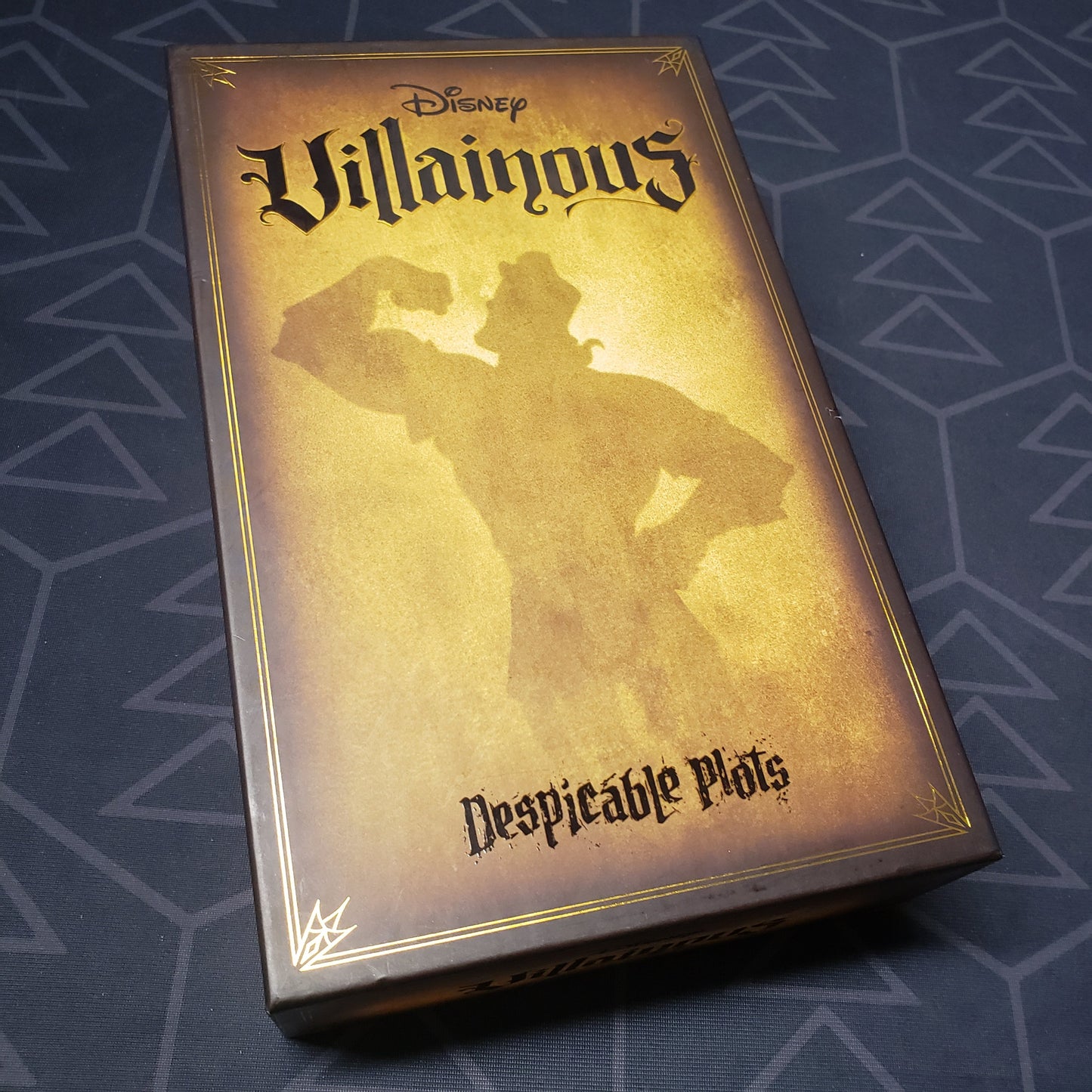 Image shows the front cover of the box for the Disney Villainous: Despicable Plots card game