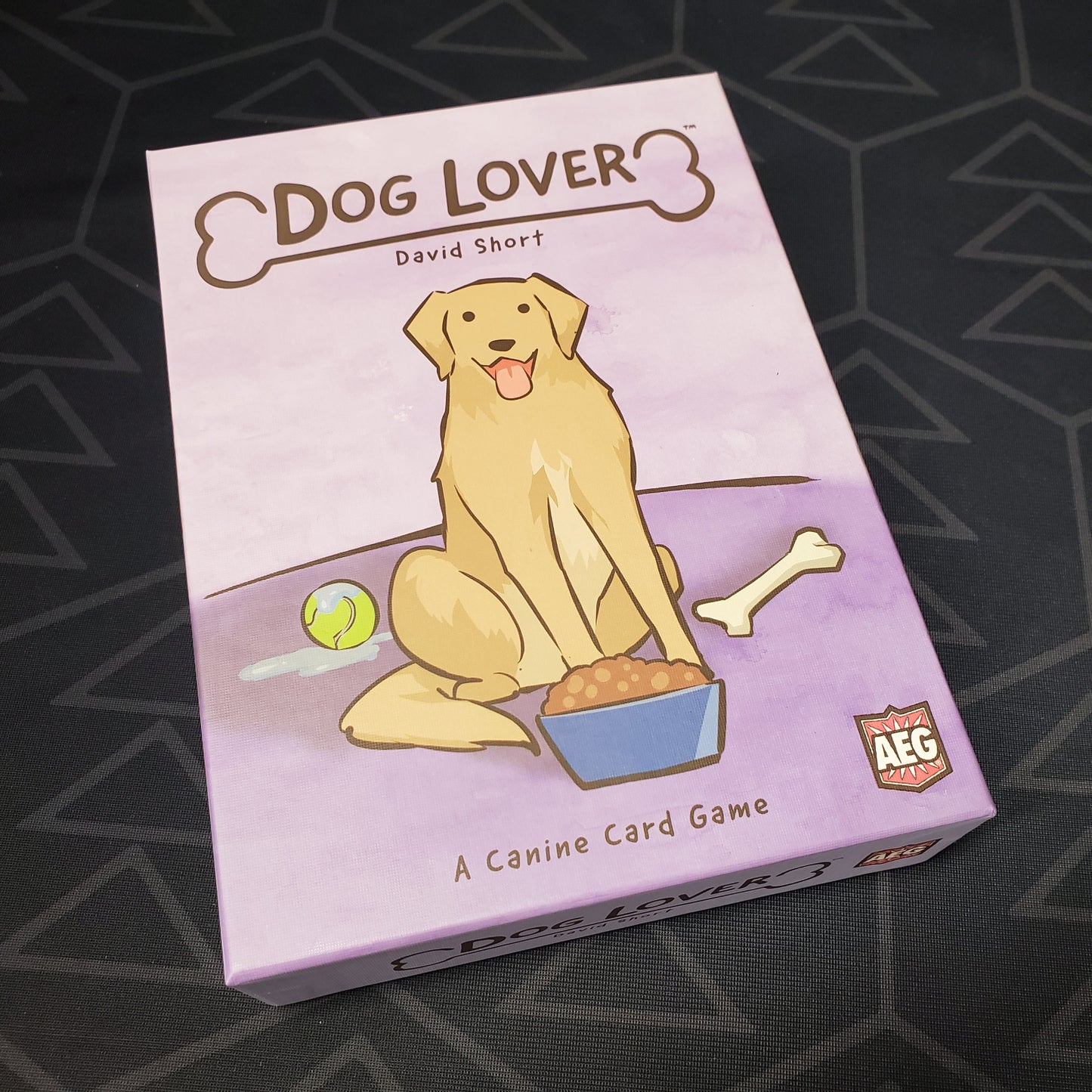 Image shows the front cover of the box of the Dog Lover card game