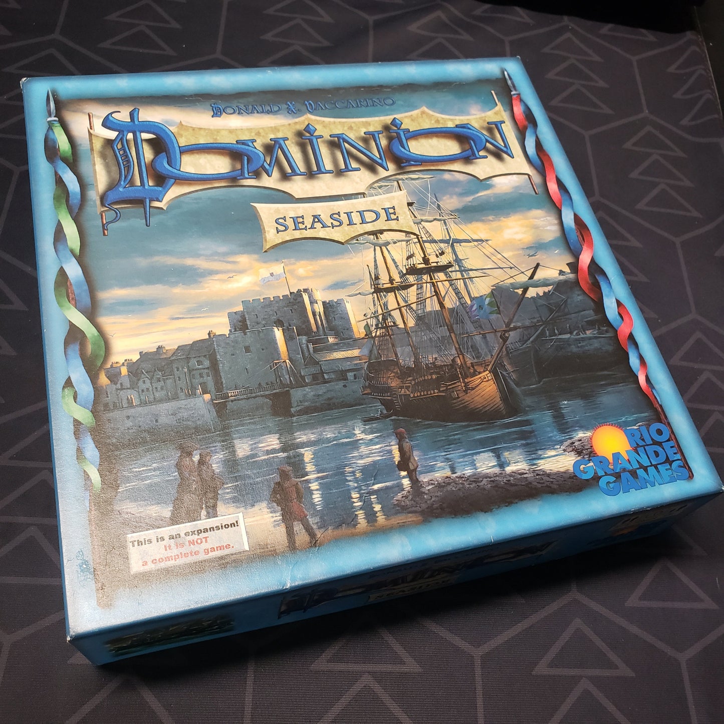 Image shows the front cover of the box for the Dominion: Seaside card game