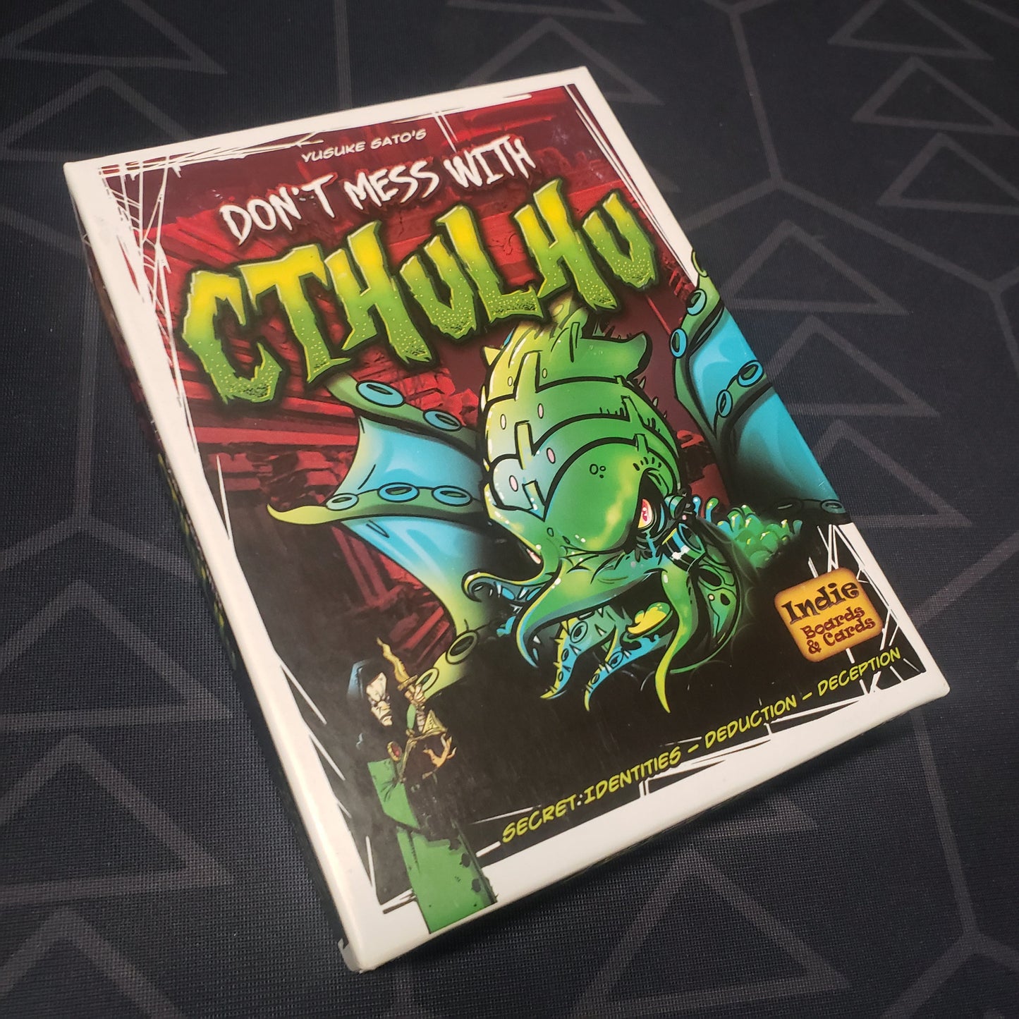 Image shows the front cover of the box of the Don't Mess With Cthulhu card game