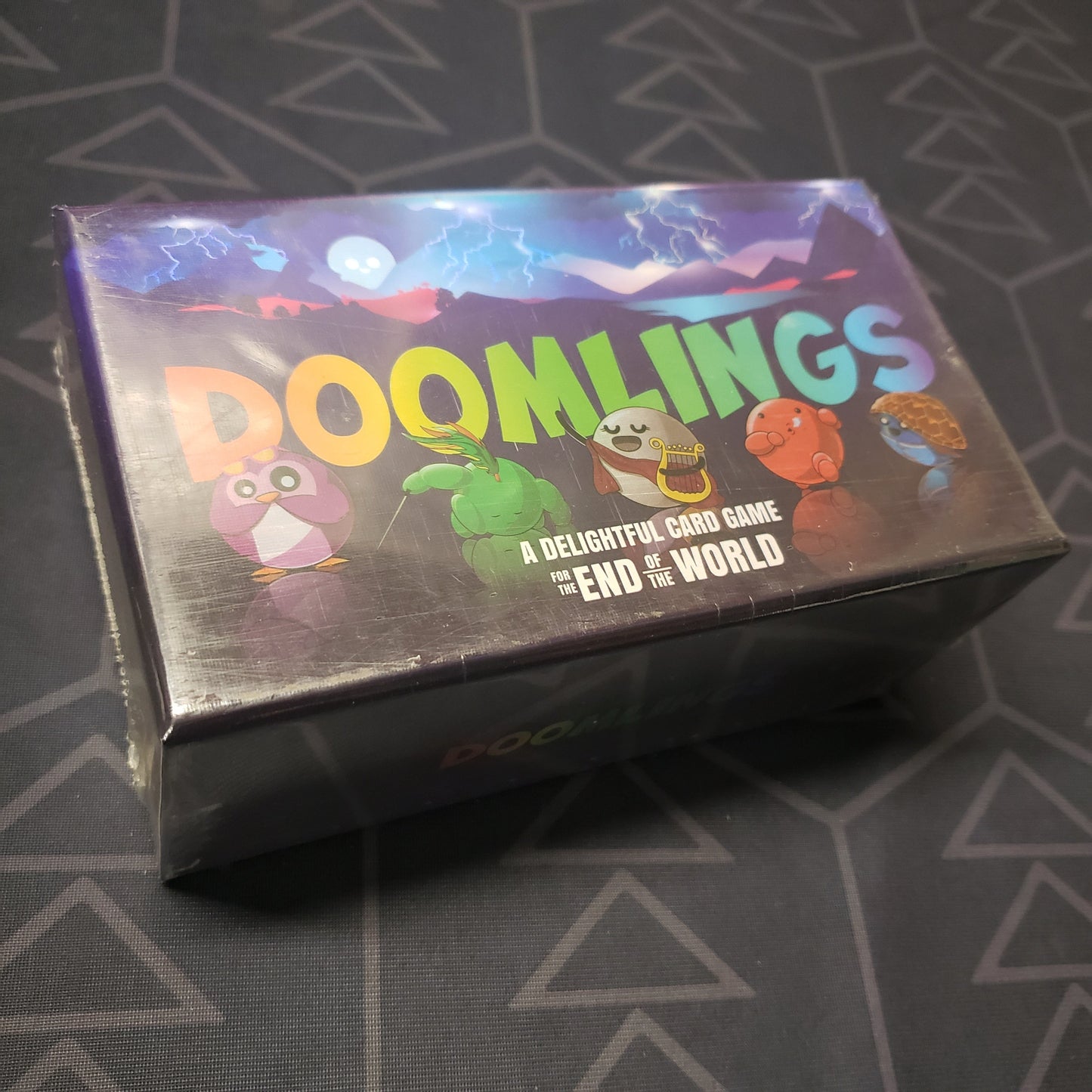 Image shows the front cover of the box of the Doomlings card game