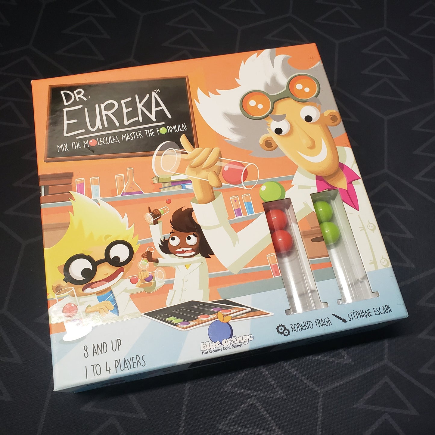 Image shows the front cover of the box for the Dr. Eureka board game