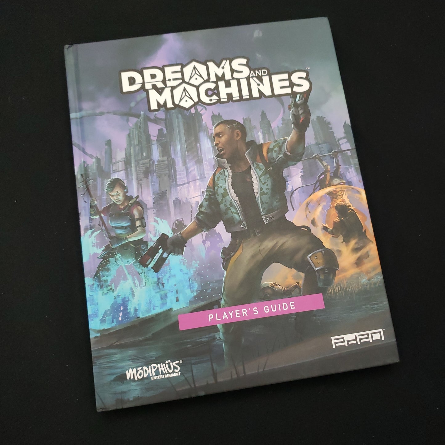 Image shows the front cover of the Player's Guide book for the Dreams and Machines roleplaying game