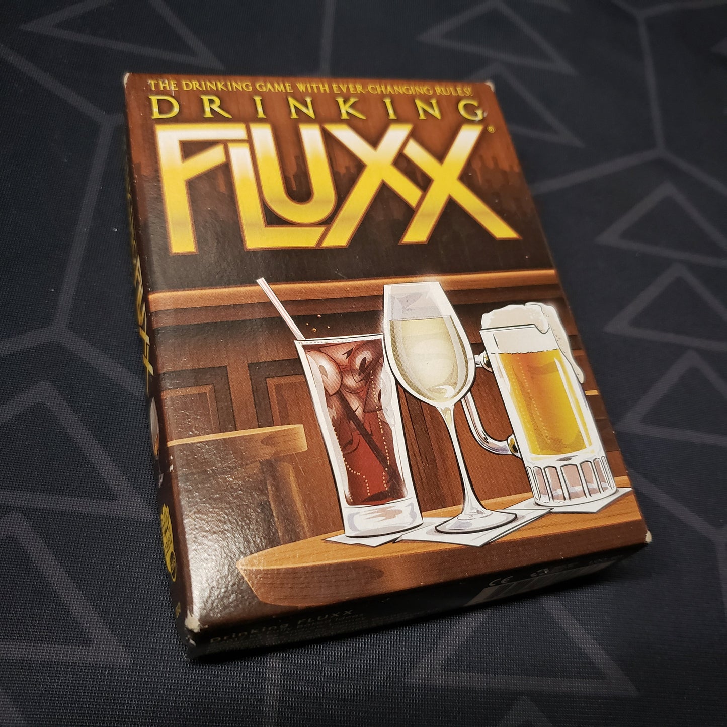 Image shows the front cover of the box of the Drinking Fluxx card game