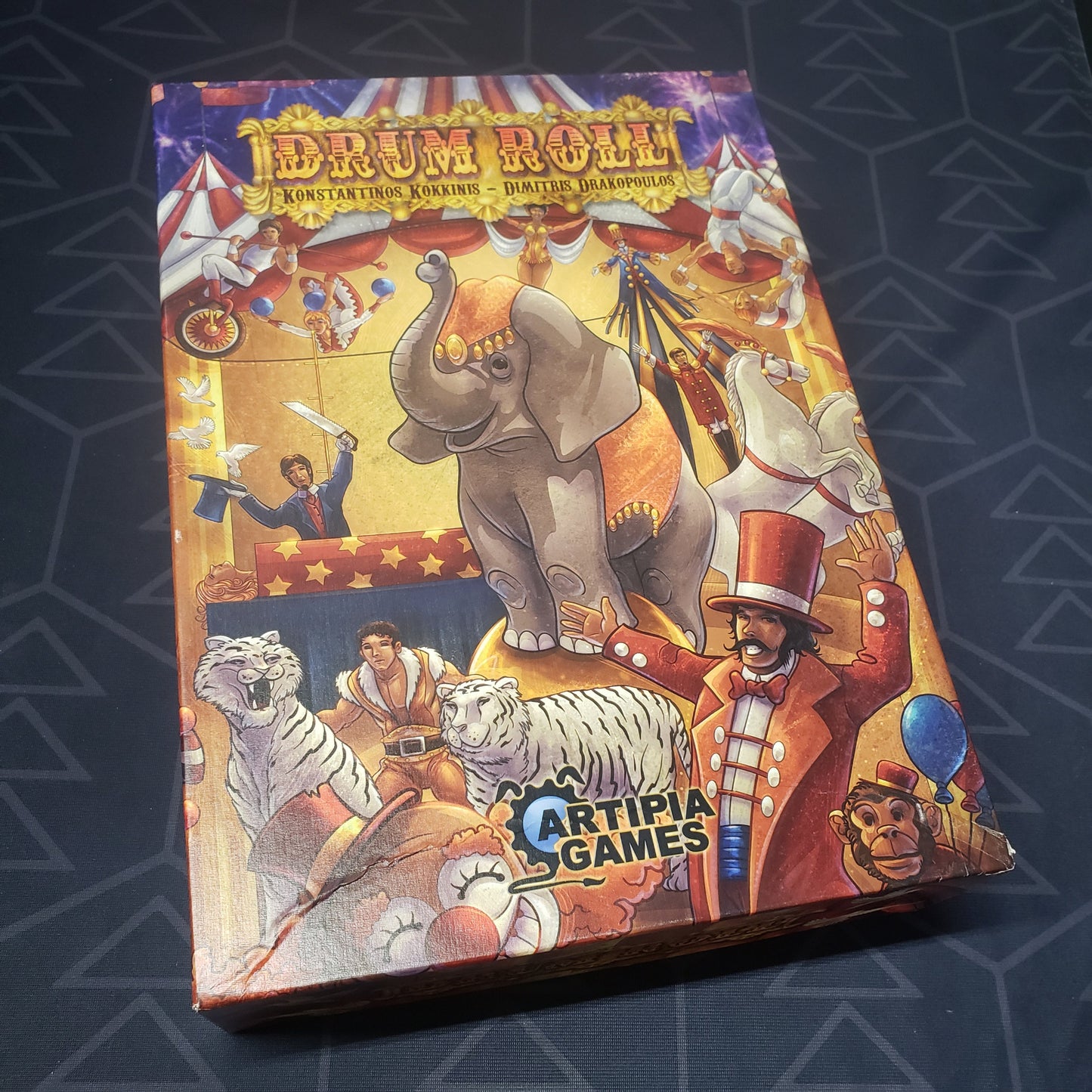 Image shows the front cover of the box of the Drum Roll board game